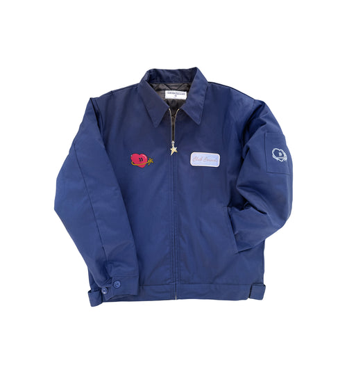 Navy utility jacket with an embroidered patch and heart and star graphic on a white background.