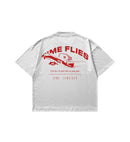 White shirt with red text and Club Cosmo's graphics on a white background.