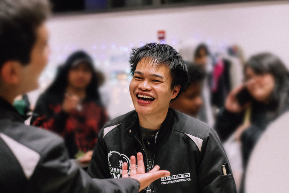 Club Cosmo's CEO smiling talking to another crew member.