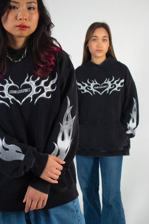 Two models wearing black and silver Club Cosmo's hoodies.