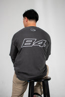 Model with their back turned showing off a grey Club Cosmo's long sleeve with the number 84 on it.