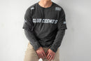 Model wearing a black long-sleeve shirt with 'CLUB COSMO'S' text and graphics on a white background.