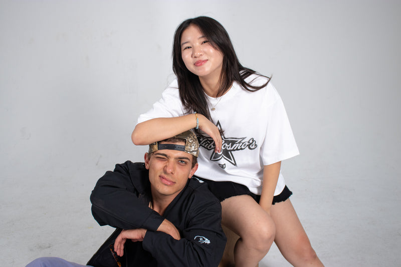 Two Club Cosmo's models posing together with branded clothing against a plain white background.