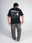Model wearing a black tee with inspirational text and an eight ball graphic on the back, standing against a plain background.
